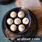 close up image of no cook malai ladoo placed in a dabba
