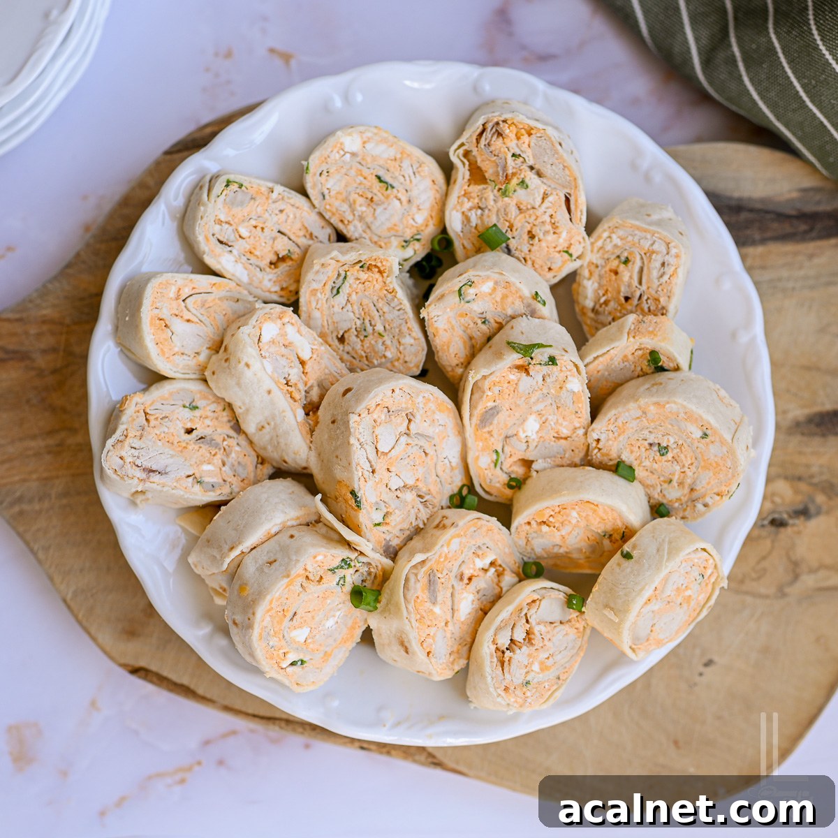 Buffalo Chicken Pinwheels Recipe — Spicy Appetizer Roll-Ups 12 plate of buffalo chicken pinwheels.
