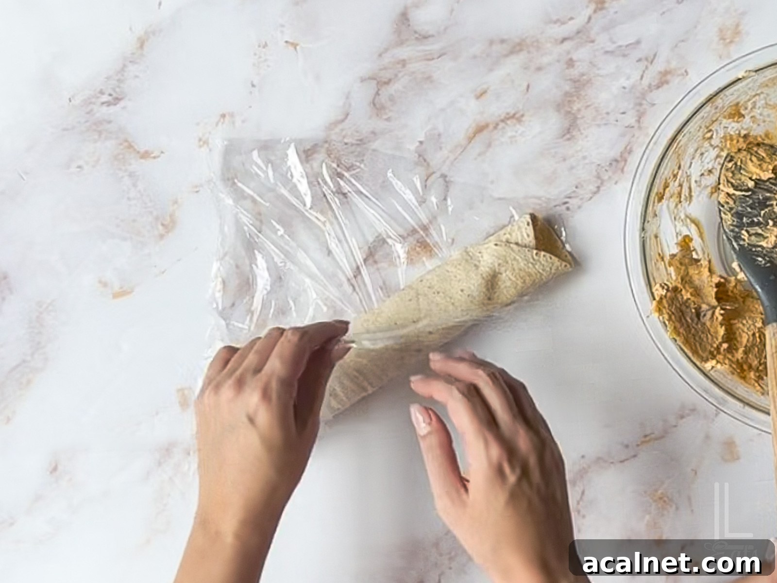 Buffalo Chicken Pinwheels Recipe — Spicy Appetizer Roll-Ups 10 wrapping tortilla roll-up in plastic wrap.