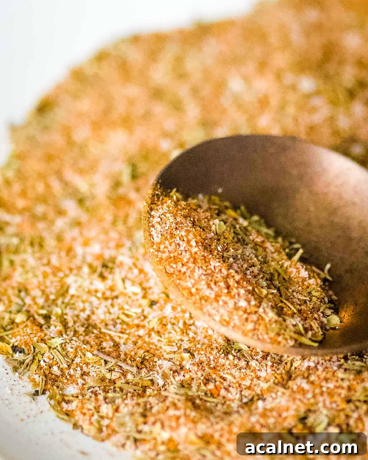 Closeup shot of homemade blackening seasoning on a copper spoon.