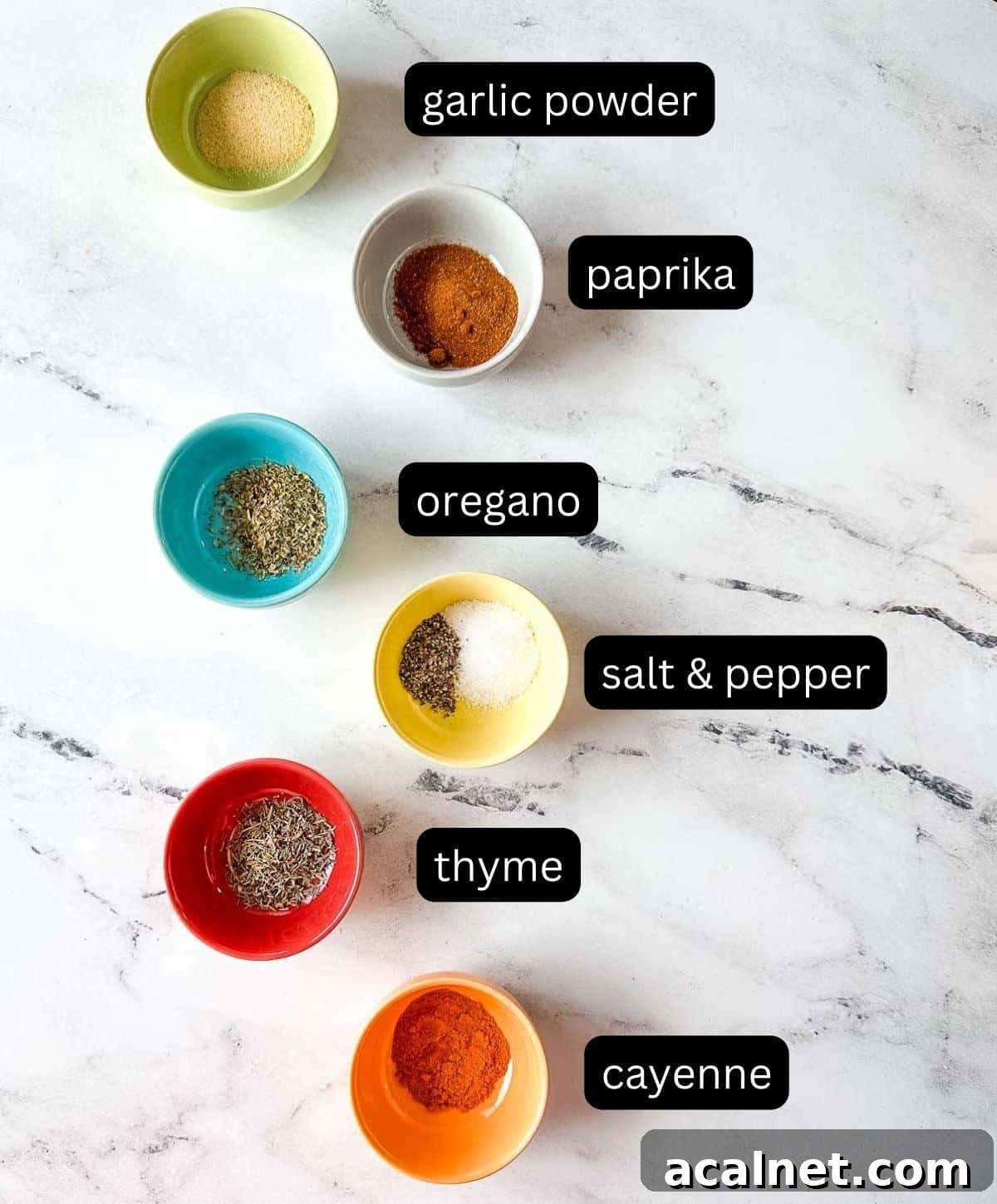Labeled ingredients for blackening spice on a white marble counter.