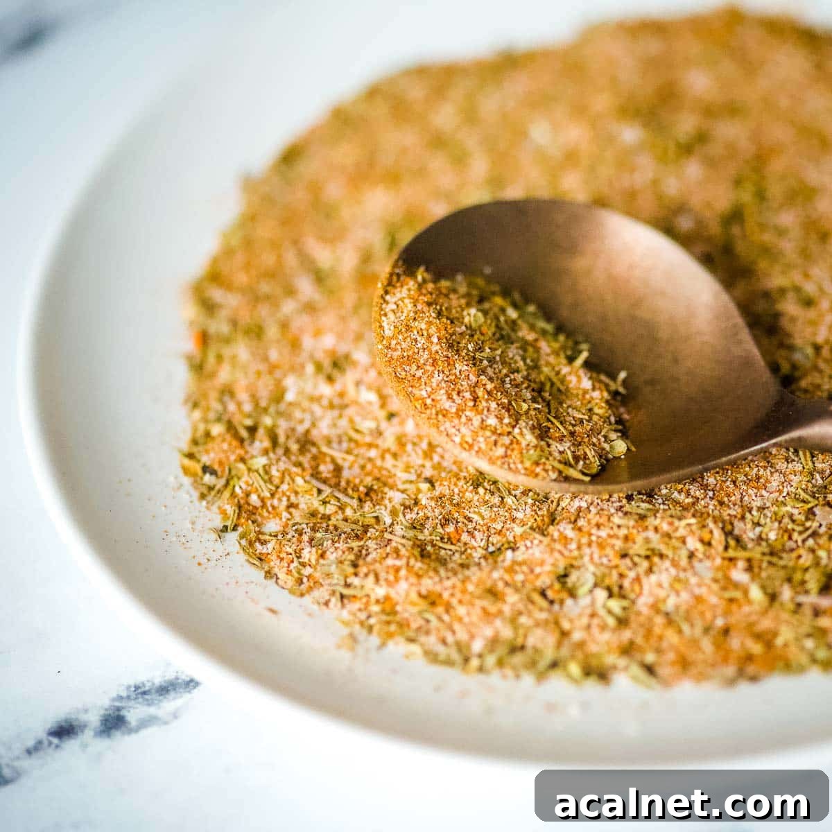 Closeup shot of homemade blackening seasoning on a copper spoon.