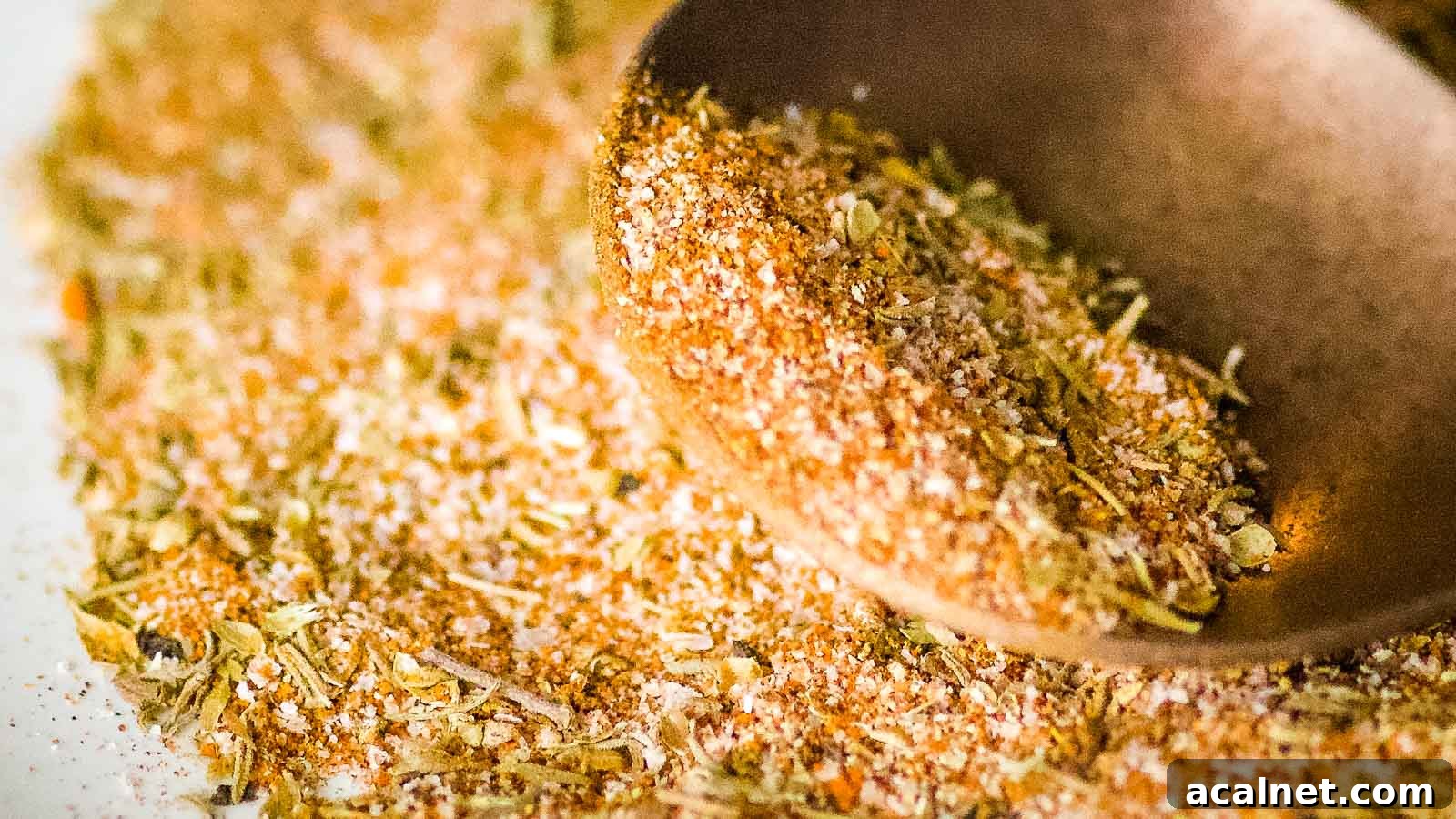 Closeup shot of homemade blackening seasoning on a copper spoon.