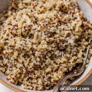 overhead view of cooked quinoa in a bowl with a fork.