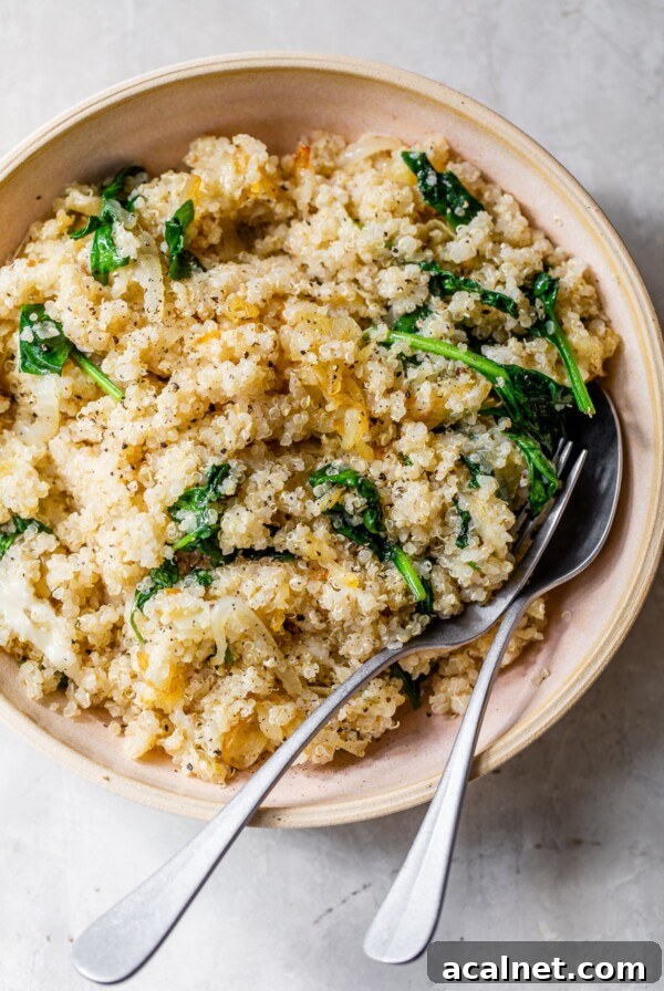 quinoa, onions and spinach in a pink bowl