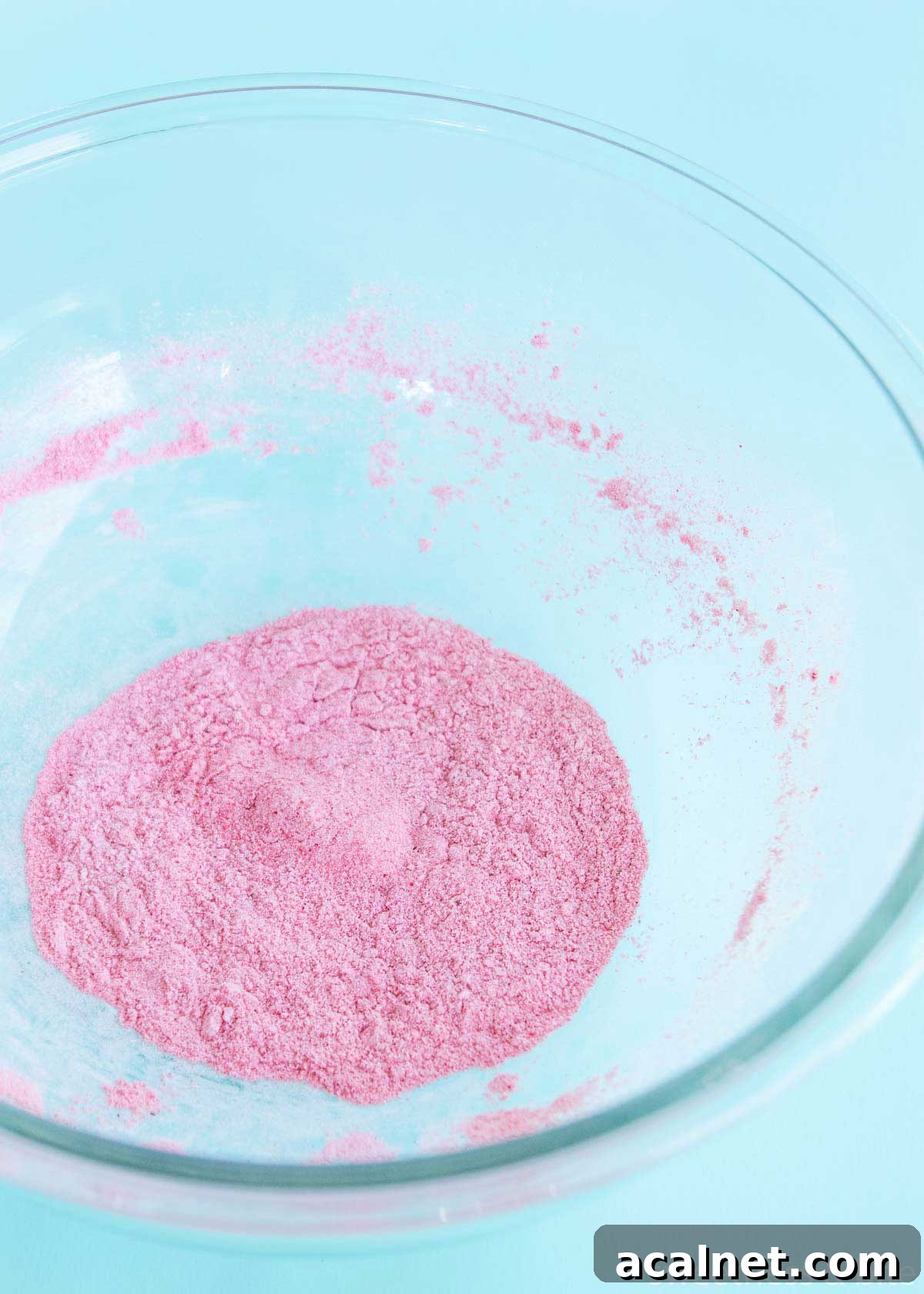 Freeze dried raspberry powder and icing sugar mixed together in a large bowl.