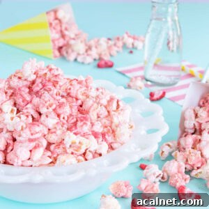White bowl of pink fruit-flavoured popcorn.