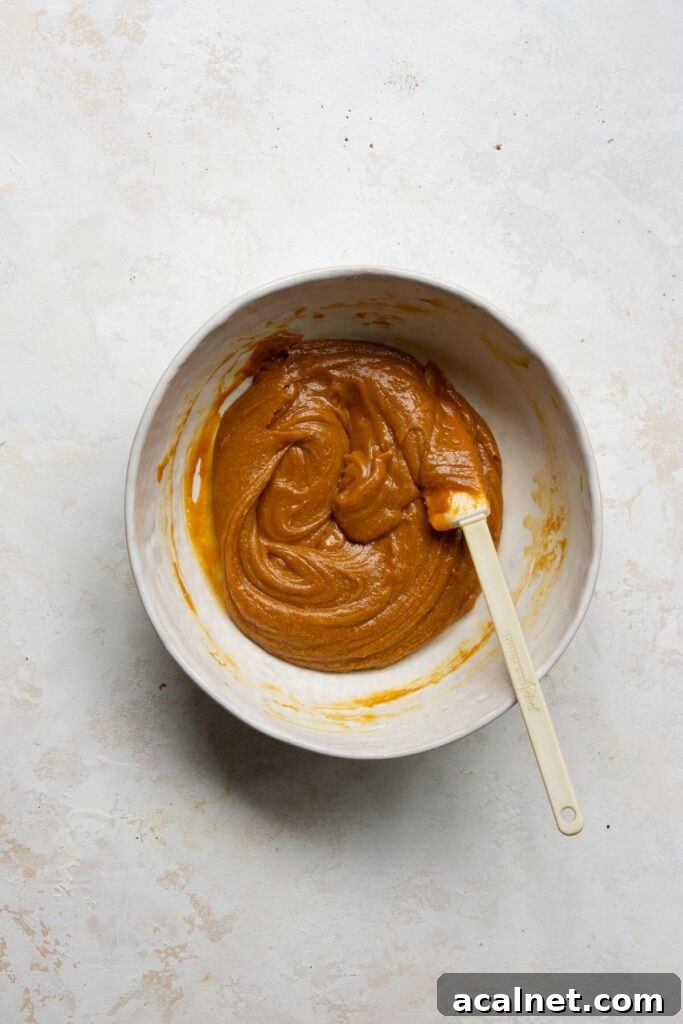 combining all the wet ingredients in a mixing bowl before adding mashed sweet potato