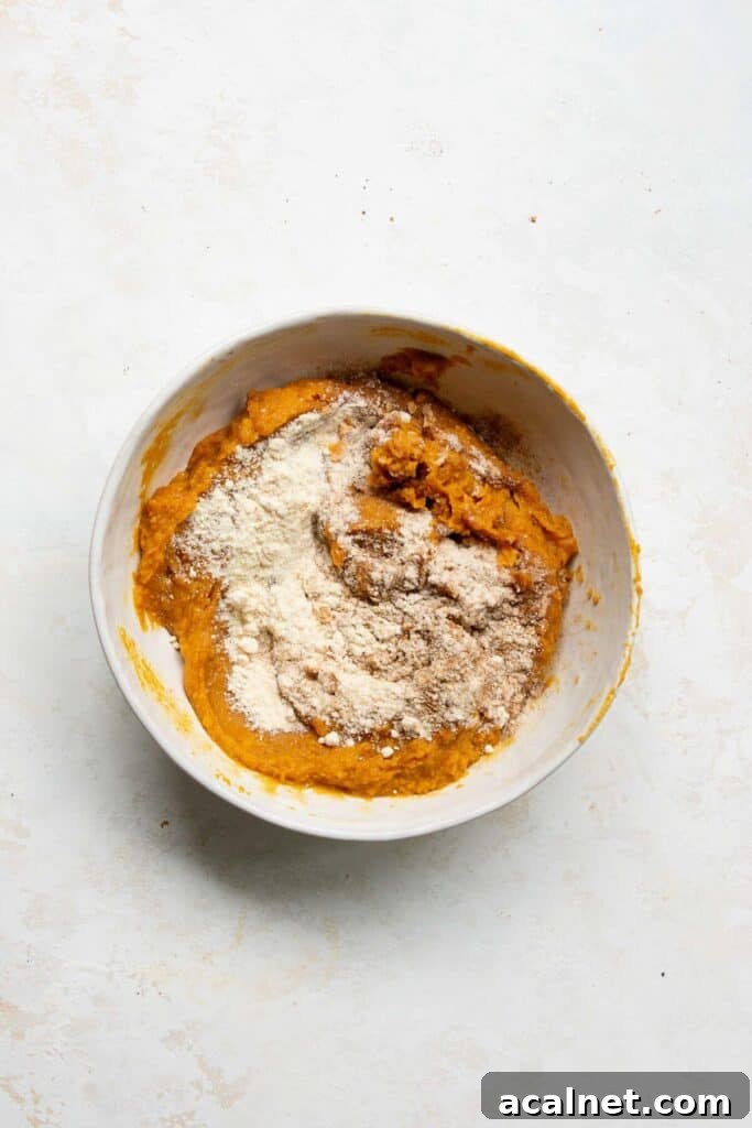 adding dry ingredients to the mixing bowl