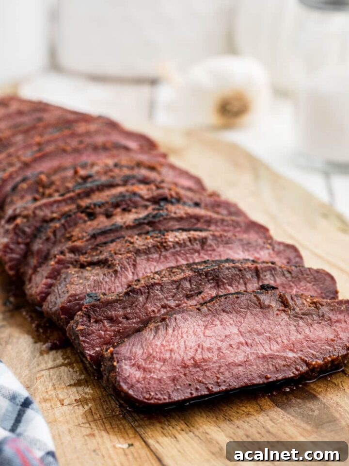 smoked venison backstrap sliced on a board