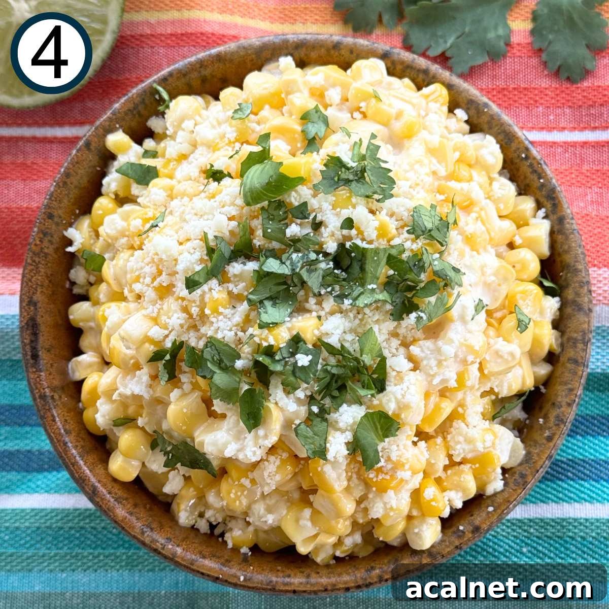 Mexican Street Corn Cups Recipe – Creamy Elote in a Cup 7 Mexican street corn in a brown serving bowl topped with Cotija cheese and chopped cilantro.