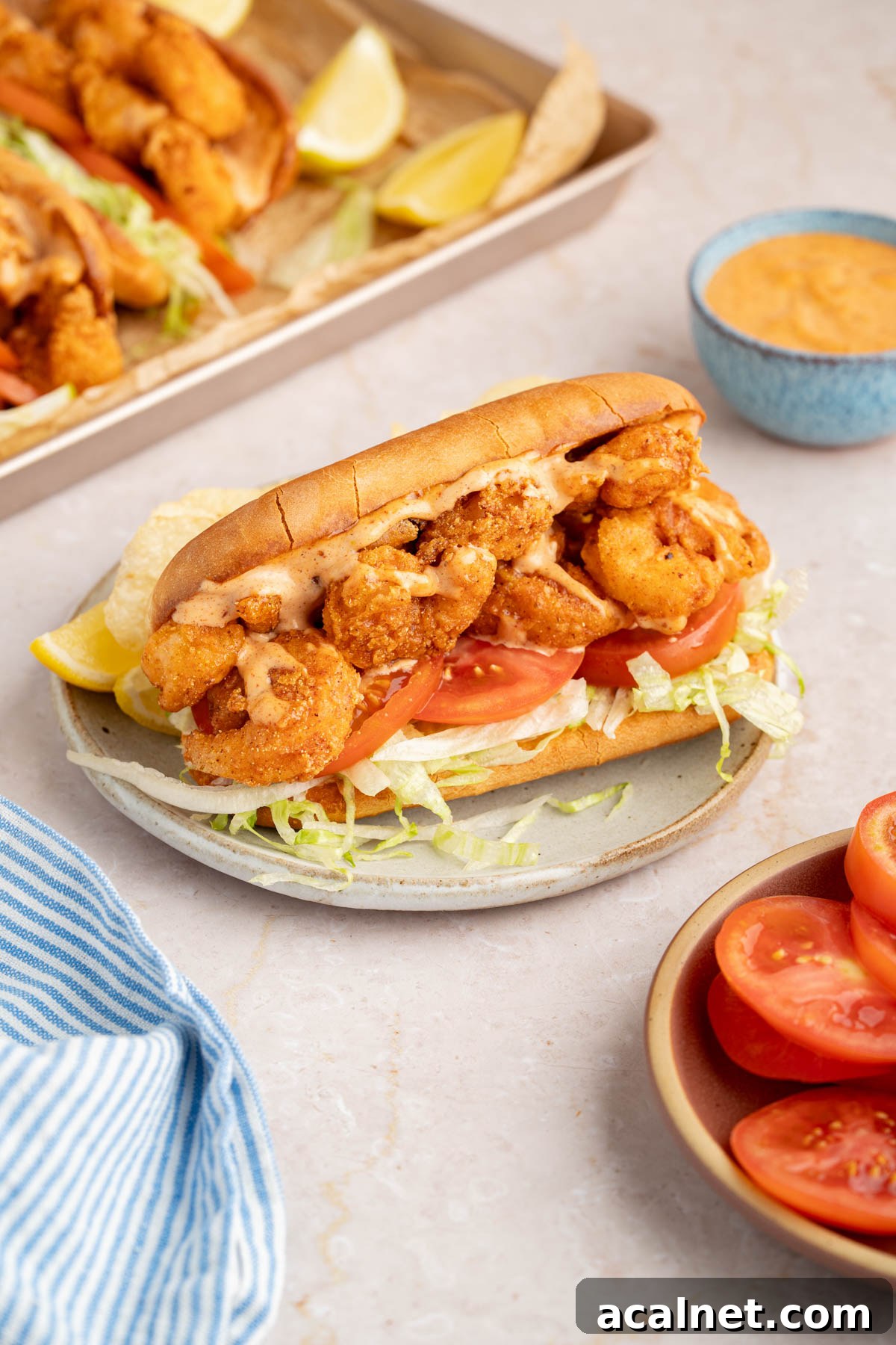 Crispy Shrimp Po' Boy Sandwich Recipe for Classic New Orleans Flavor 11 The final shrimp po' boy assembled on a plate for serving.