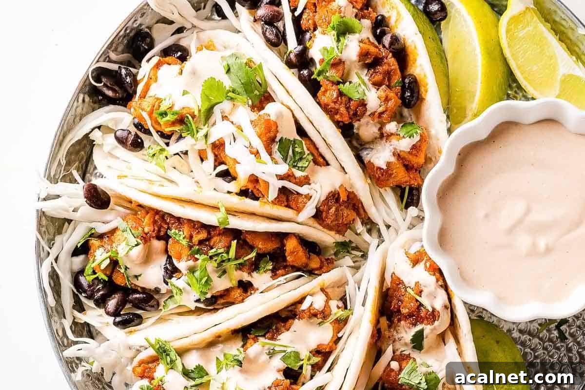 chipotle chicken tacos in tray with sauce on the side
