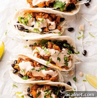 chipotle chicken tacos on paper with limes