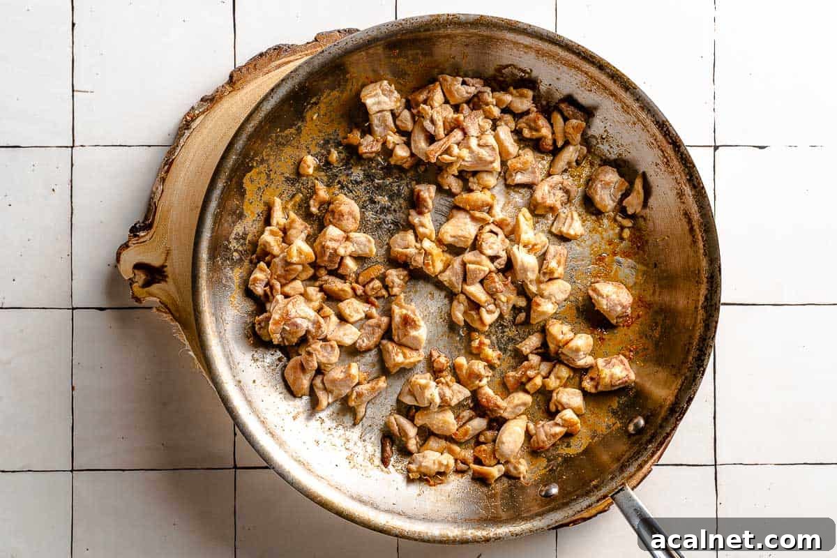 chicken pieces browning in pan