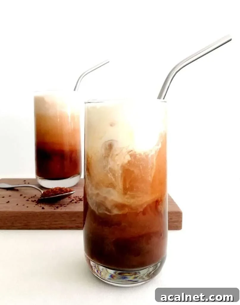 How to Make Rich, Refreshing Iced Coffee at Home 2 iced coffee in cups with whipped cream poured in (1)