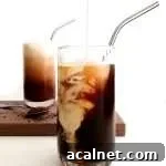 iced coffee in glasses pouring whipped cream into cup