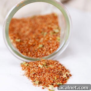 square crop of a glass jar filled with spice mix that's been tipped over.