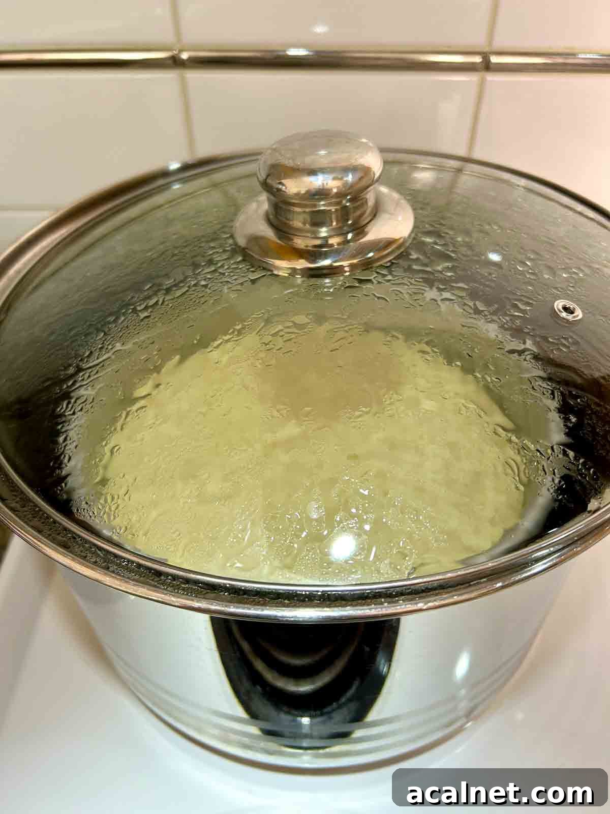 cake being steamed in large pot.