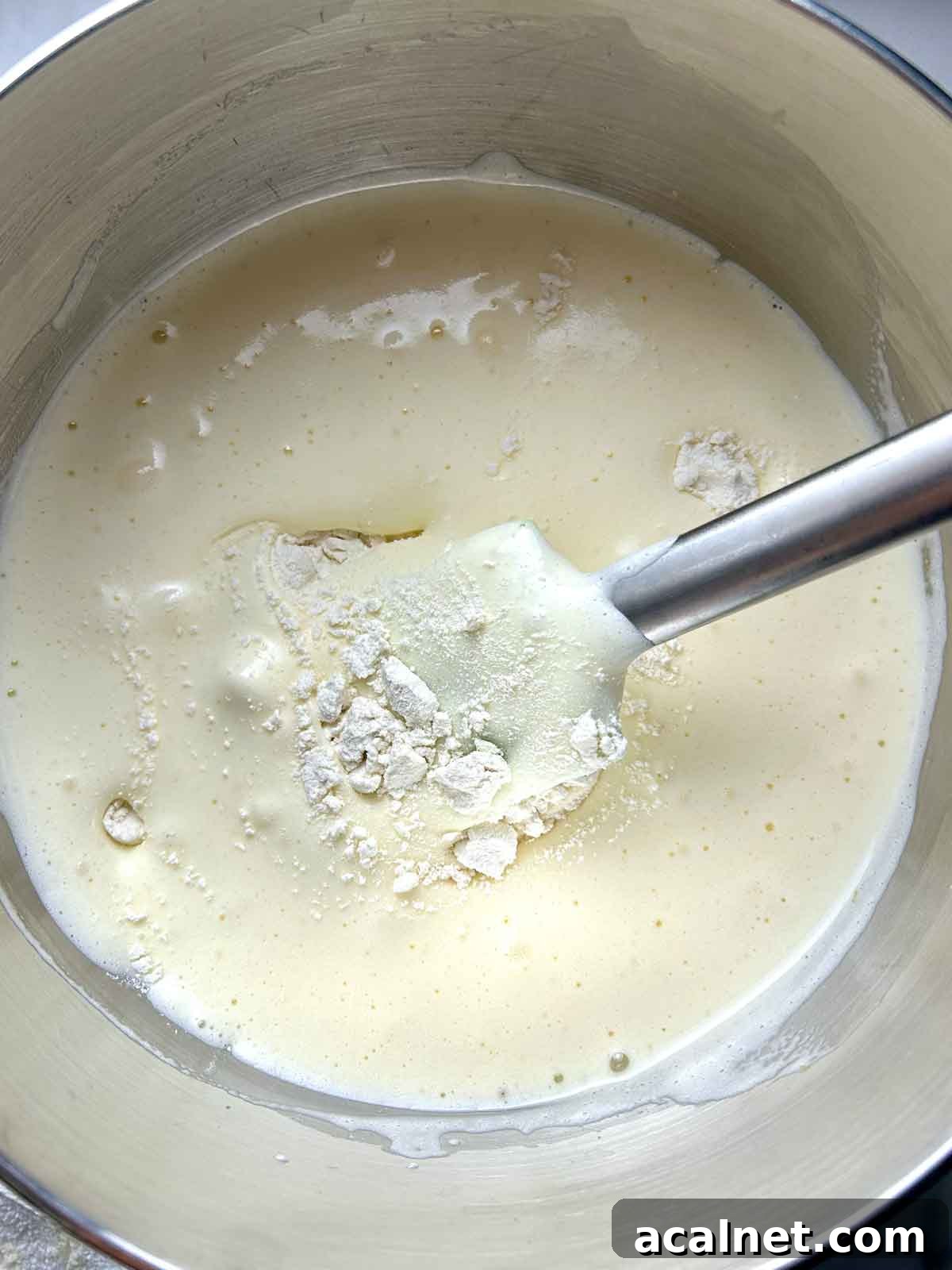 flour being folded into wet batter.