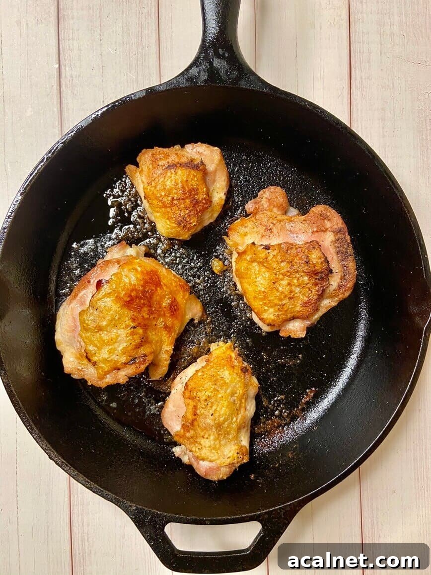 Spicy Buffalo Chicken Thighs with Crispy Skin and Blue Cheese Dip 5 Chicken finished cooking in pan.