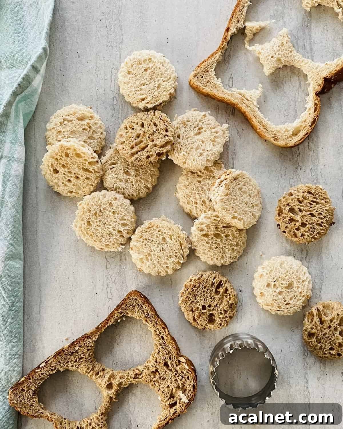 Rounds of bread cut out of slices of bread for blt bites.
