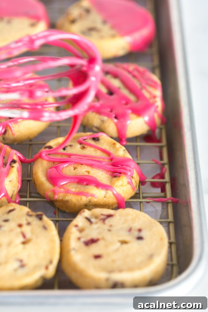 Drizzling the Glazed Hibiscus Shortbread Cookies with glaze