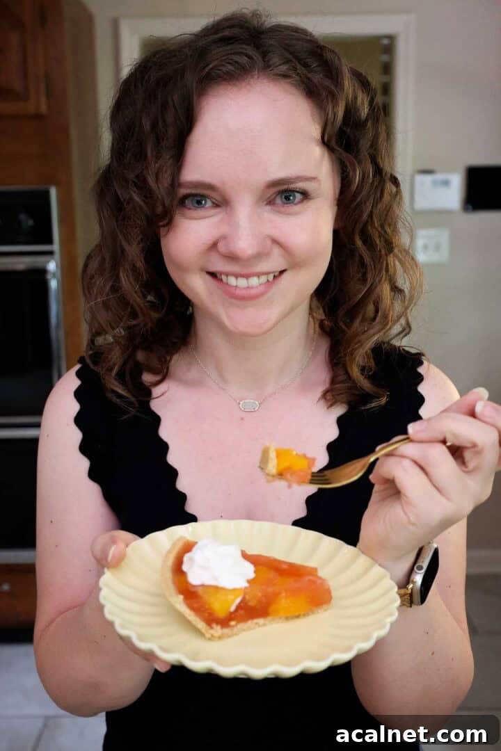 Kelsey Smith holding a plate with a slice of peach Jello pie.