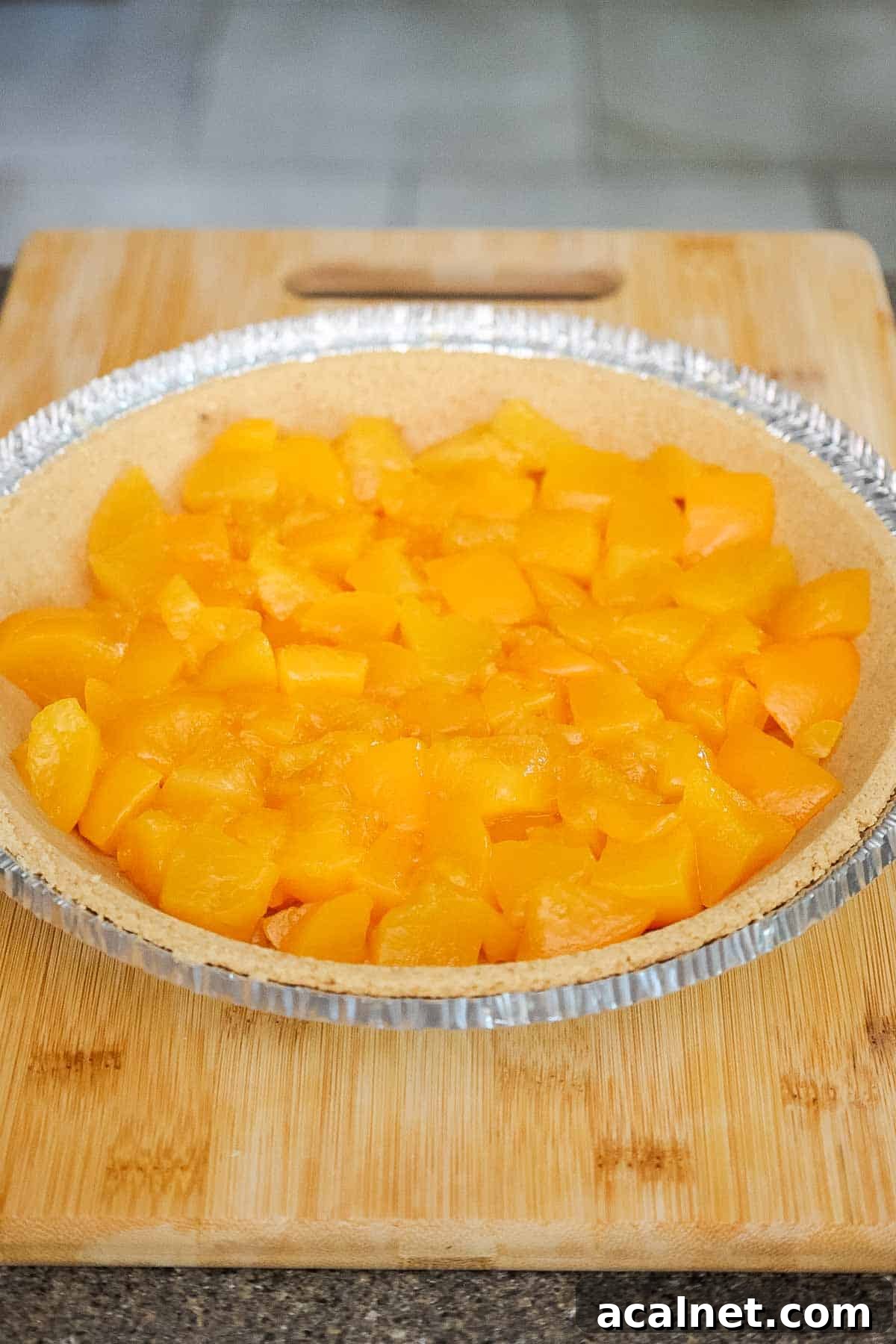 A graham cracker crust filled with canned peach chunks.