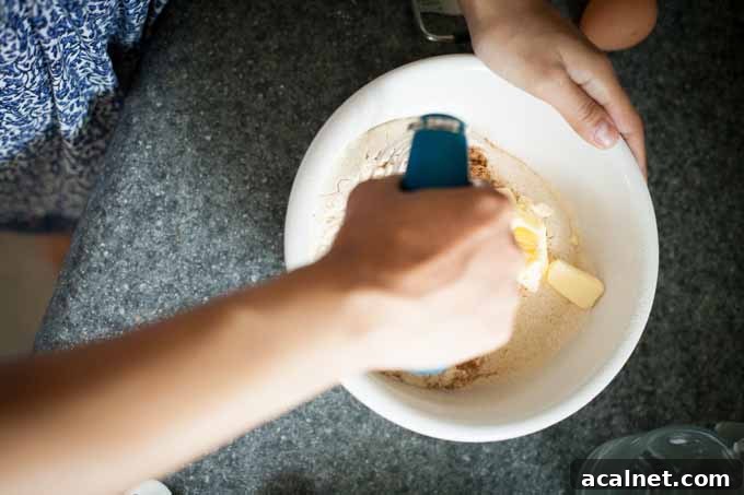 Overhead shot of the author mixing the dry ingredients in a white, ceramic bowl.