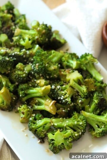 Broccoli with teriyaki sauce on plate.