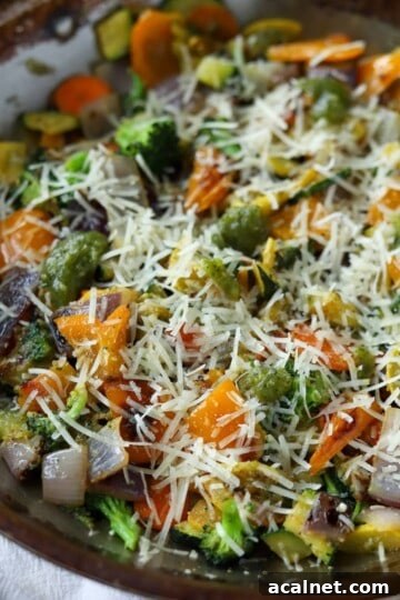 Pesto veggies in pan with cheese.