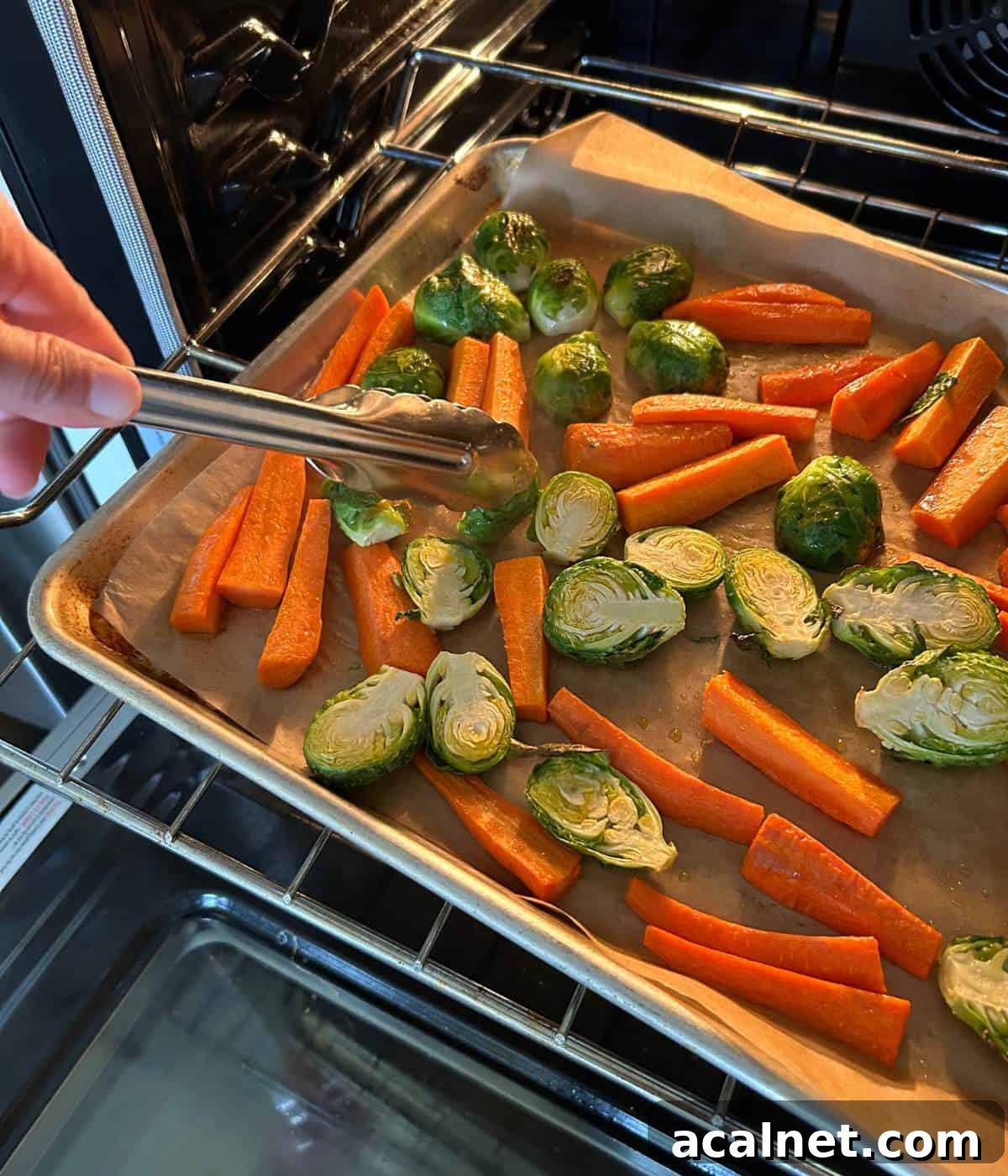 Flipping vegetables half way through oven roasting.