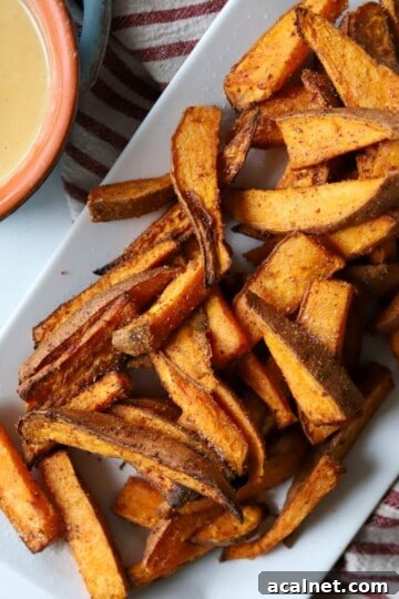 Sweet potato wedges on platter with honey mustard.