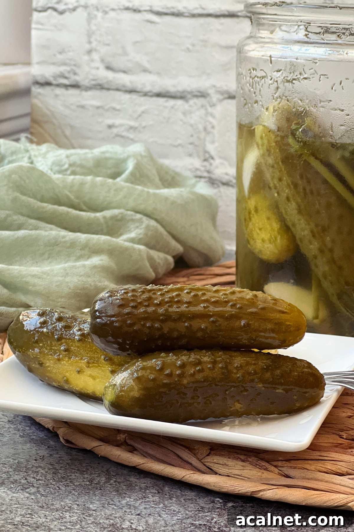 Fermented whole cucumbers stacked on a plate ready to be served.