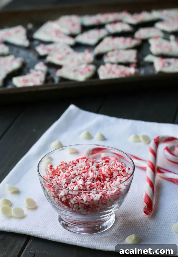 bowl of crushed peppermint candy next to white chocolate chips and candy canes