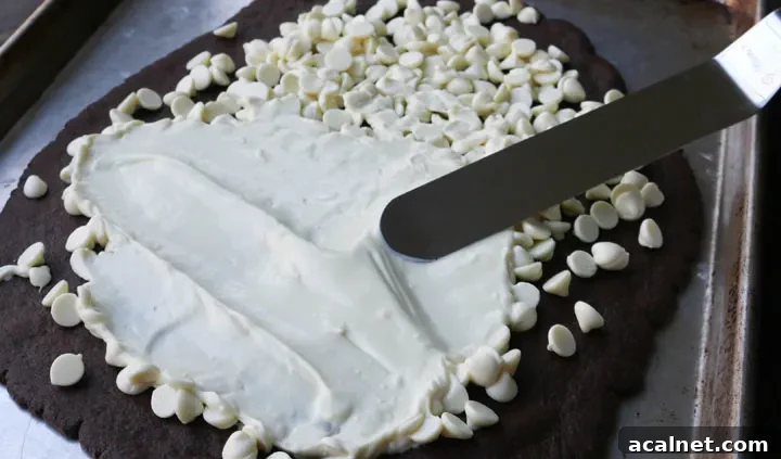 spreading melted white chocolate chips with a spatula