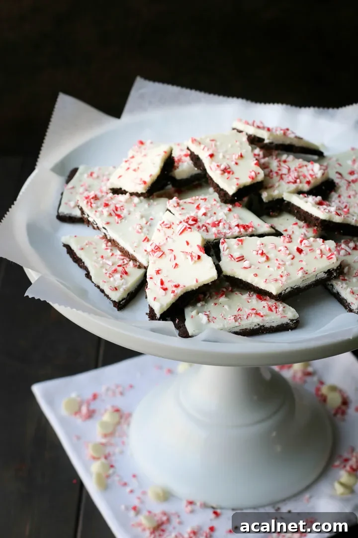 white pedestal stand filled with peppermint chocolate cookie bark
