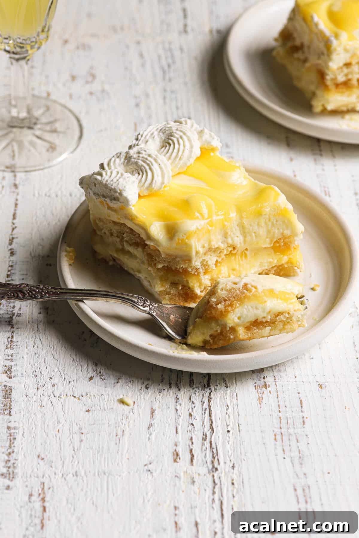 Limoncello Tiramisu Recipe: A Refreshing Citrus Twist on Tiramisu 7 A piece of lemoncello dessert with a fork.