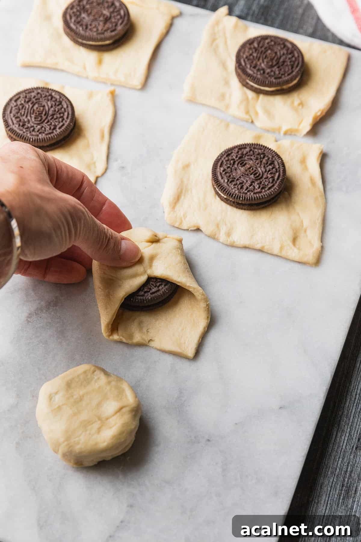 Air Fryer Oreo Bites — 3-Ingredient Dessert Recipe 6 Wrapping dough over cookies.