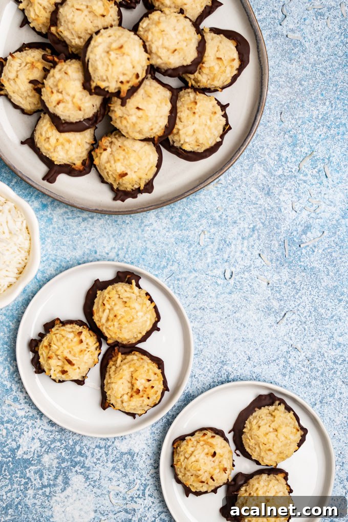 Coconut macaroons on several plates on a light blue background. 