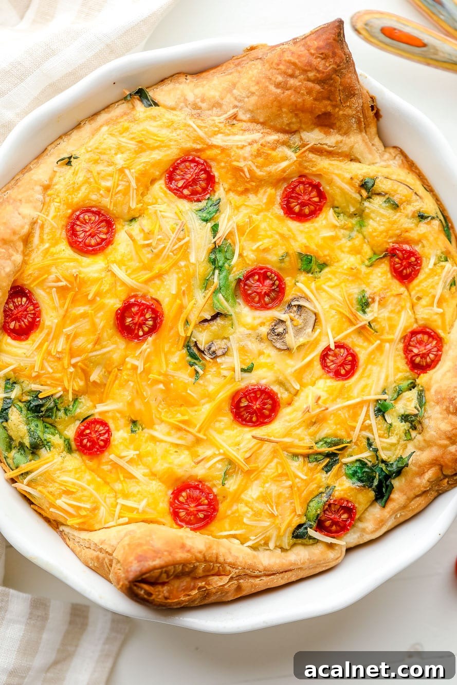 Vegan Just Egg Quiche Recipe: Flaky Crust & Creamy Filling 4 Close up on a baked JUST Egg quiche in a white pie plate.