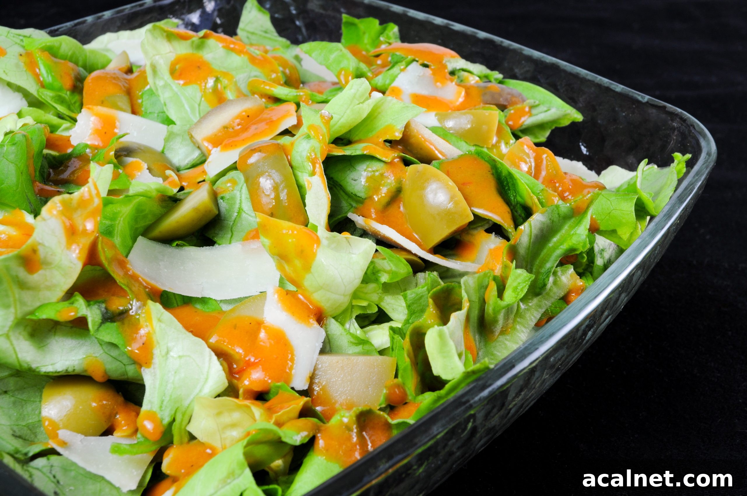 Butter Leaf Salad with Cerignola Olives, Shaved Parmesan, and Roasted Tomato Vinaigrette