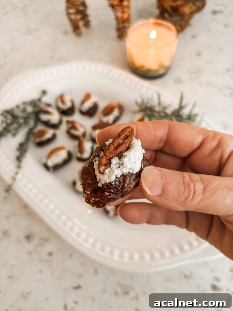 Marie holding up one of the Stuffed Dates with Cheese and Herbs