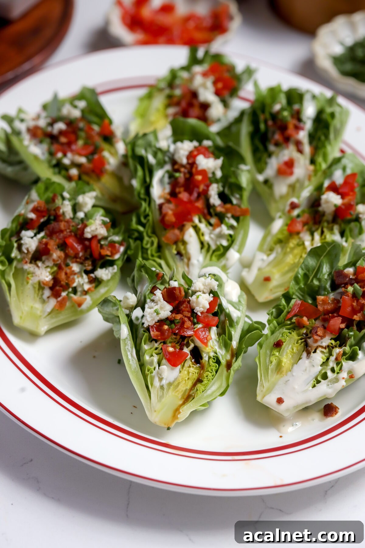 A wedge of romaine lettuce with blue cheese dressing, bacon bits, tomatoes, it has the best flavor and is handheld!