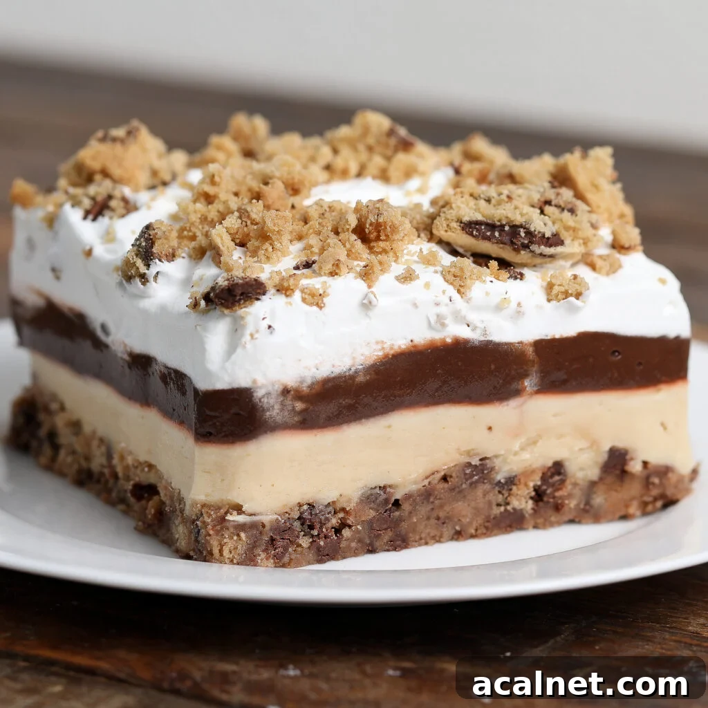 A no-bake square slice of layered dessert with a cookie crumb base, creamy beige layer, chocolate pudding, and whipped cream, topped with crumbled cookies, served on a white plate.
