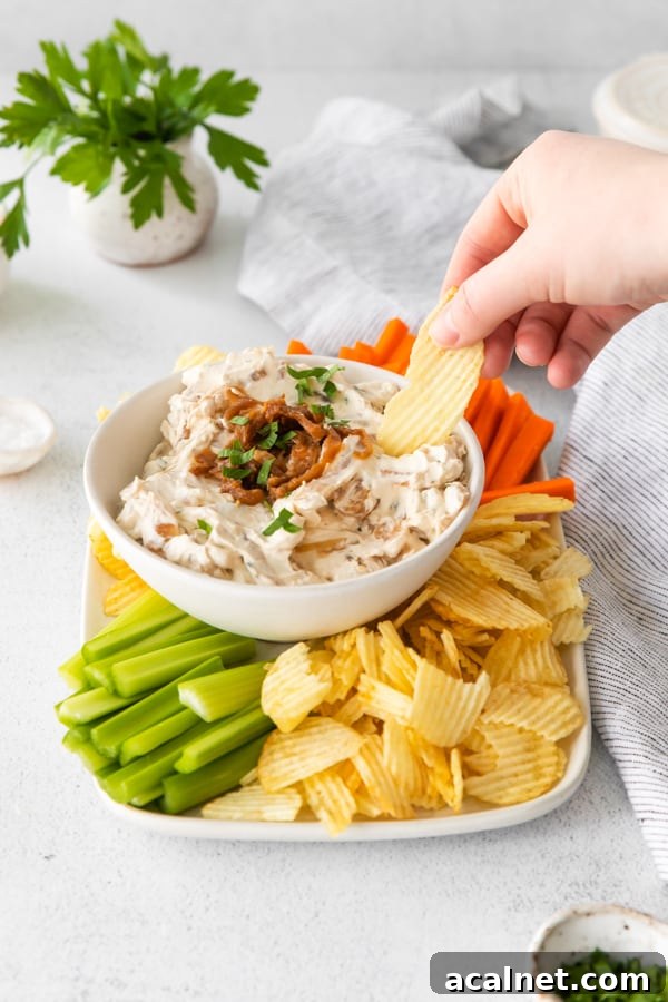 Using a chip to scoop up some French Onion Dip. 