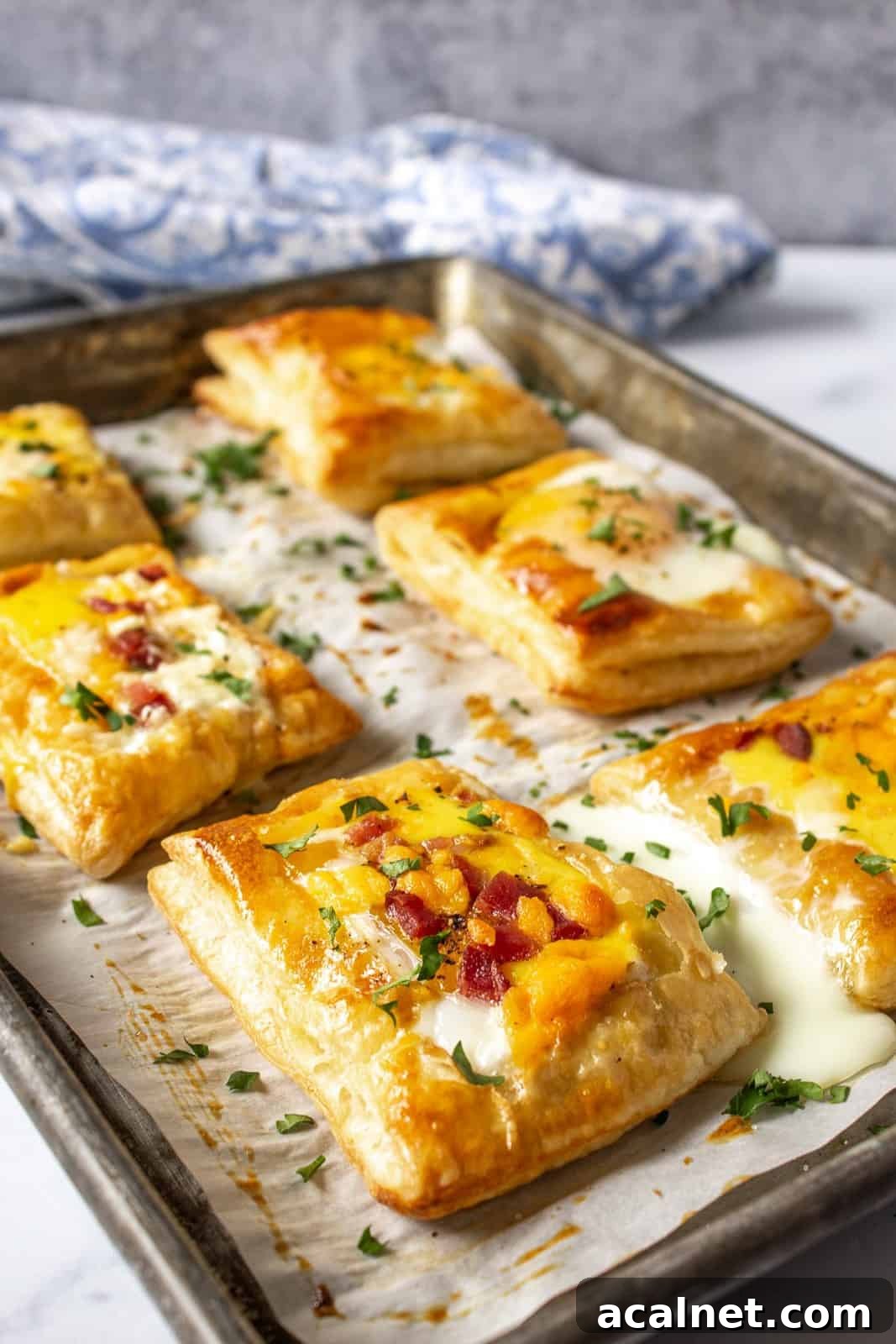 A baking sheet with puff pastry topped with baked eggs.