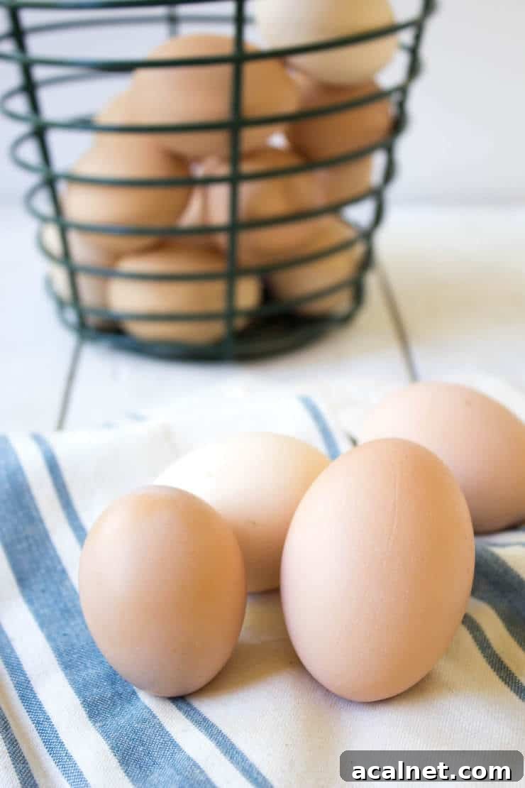 Different colored eggs on a stiped napkin.