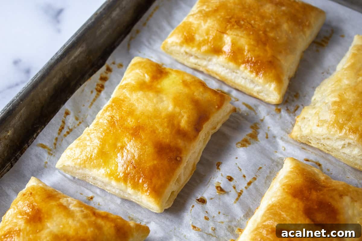 Puff pastry squares on a baking sheet.